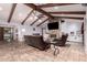 Bright living room featuring vaulted ceilings, a stone fireplace, and tile flooring at 1907 E Huber St, Mesa, AZ 85203
