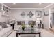 Inviting living room with a neutral color palette, stylish decor, and comfortable seating arrangement at 1907 E Huber St, Mesa, AZ 85203