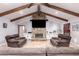 Comfortable living room with vaulted ceiling, stone fireplace, tile flooring, and cozy seating arrangement at 1907 E Huber St, Mesa, AZ 85203