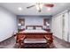Serene main bedroom with a traditional wooden bed frame, side tables, and soft blue walls at 1907 E Huber St, Mesa, AZ 85203