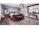 Cozy main bedroom featuring a wooden bed frame, soft lighting, and a spacious layout at 1907 E Huber St, Mesa, AZ 85203