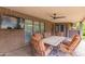 Covered patio space with outdoor dining area, mounted TV and ceiling fan at 1907 E Huber St, Mesa, AZ 85203
