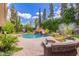 Stunning backyard pool with waterfall feature, lush landscaping and water slide at 1907 E Huber St, Mesa, AZ 85203
