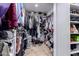 Spacious walk-in closet with custom shelving and ample storage for clothes and accessories at 1907 E Huber St, Mesa, AZ 85203
