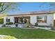The back exterior features a well-manicured yard, patio, and a covered seating area, perfect for outdoor living at 19215 N 259Th Ave, Buckeye, AZ 85396