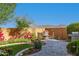 Scenic backyard with verdant lawn, brick walls, professional landscaping, and inviting outdoor seating area at 19215 N 259Th Ave, Buckeye, AZ 85396