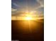 Backyard view showing a radiant sunset over the desert landscape at 19215 N 259Th Ave, Buckeye, AZ 85396