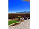 Desert backyard featuring pavers, rock garden, and outdoor seating at 19215 N 259Th Ave, Buckeye, AZ 85396