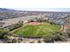 Aerial view of a well-maintained baseball field surrounded by lush green grass at 19215 N 259Th Ave, Buckeye, AZ 85396