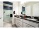 Elegant bathroom features double sinks, granite countertops, and a large walk-in shower with glass doors at 19215 N 259Th Ave, Buckeye, AZ 85396