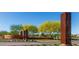 Sun City Festival entrance with decorative rusted metal art installation and landscaping at 19215 N 259Th Ave, Buckeye, AZ 85396