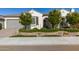 Charming single-story home featuring lush landscaping, beautiful stonework and a neutral-toned exterior at 19215 N 259Th Ave, Buckeye, AZ 85396