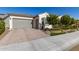 Charming single-story home featuring lush landscaping, beautiful stonework, three car garage and a neutral exterior at 19215 N 259Th Ave, Buckeye, AZ 85396