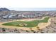 Aerial view of a golf course with sand traps in a residential community and desert vegetation at 19215 N 259Th Ave, Buckeye, AZ 85396