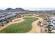 Scenic view of a meticulously kept golf course amidst a residential community and desert landscape at 19215 N 259Th Ave, Buckeye, AZ 85396