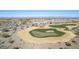 Picturesque aerial view of a golf course, showcasing lush greens, sand traps, and water features at 19215 N 259Th Ave, Buckeye, AZ 85396