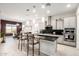 Open-concept kitchen with modern appliances, granite countertops and a breakfast bar at 19215 N 259Th Ave, Buckeye, AZ 85396