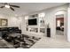 Inviting living room with modern built-ins, neutral walls and a comfortable black leather couch at 19215 N 259Th Ave, Buckeye, AZ 85396