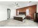 A primary bedroom featuring an accent wall, neutral carpet, and an ensuite doorway at 19215 N 259Th Ave, Buckeye, AZ 85396