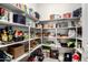 A walk-in pantry filled with shelves stocked with groceries and household items for organized storage at 19215 N 259Th Ave, Buckeye, AZ 85396