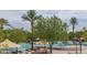 Sun City Festival pool area with shaded seating and mature palm trees at 19215 N 259Th Ave, Buckeye, AZ 85396