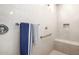 A tiled shower with a built-in bench, shower head, and grab bar at 19215 N 259Th Ave, Buckeye, AZ 85396