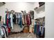 A walk-in closet featuring clothing racks and shelves for organized storage of clothes, shoes, and accessories at 19215 N 259Th Ave, Buckeye, AZ 85396