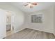 Well-lit bedroom with en-suite bathroom, featuring a window and ceiling fan at 1961 N Hartford St # 1087, Chandler, AZ 85225