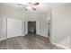 Spacious bedroom with hardwood floors, fan, walk in closet and light grey walls at 1961 N Hartford St # 1087, Chandler, AZ 85225
