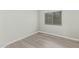 Neutral-toned bedroom showcasing a window with blinds and light hardwood-style flooring at 1961 N Hartford St # 1087, Chandler, AZ 85225