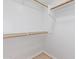 Walk-in closet featuring adjustable wood closet rods and white shelving for storage and organization at 1961 N Hartford St # 1087, Chandler, AZ 85225