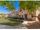 Attractive townhome with manicured lawn and walkway nestled among mature trees in a vibrant community at 1961 N Hartford St # 1087, Chandler, AZ 85225