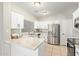 Bright kitchen featuring white cabinets, stainless steel appliances, and granite countertops at 1961 N Hartford St # 1087, Chandler, AZ 85225