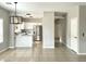Open concept kitchen features stainless steel appliances, bright white cabinetry, and a functional breakfast bar at 1961 N Hartford St # 1087, Chandler, AZ 85225