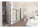 Bathroom featuring a glass door shower, luxurious tub and adjacent vanities at 20255 W Monterey Way, Buckeye, AZ 85396