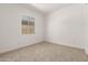 Bright bedroom featuring neutral carpet, white walls, and a window for natural light at 20255 W Monterey Way, Buckeye, AZ 85396