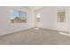 Bright bedroom with neutral carpet, white walls, and natural light from multiple windows at 20255 W Monterey Way, Buckeye, AZ 85396