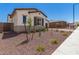 Charming single-story home with desert landscaping and a private gated driveway at 20255 W Monterey Way, Buckeye, AZ 85396