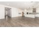 A large open living space with tile flooring, a kitchen with a center island, and plenty of natural light at 20255 W Monterey Way, Buckeye, AZ 85396