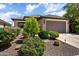 Attractive single-story home boasting a well-maintained front yard with mature trees and shrubs at 20523 N 267Th Ln, Buckeye, AZ 85396