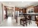 Modern kitchen featuring stainless steel appliances, dark cabinets, and breakfast bar seating at 20523 N 267Th Ln, Buckeye, AZ 85396