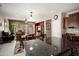 Bright kitchen flows into the dining and living rooms, featuring an island with dark granite countertops at 20523 N 267Th Ln, Buckeye, AZ 85396