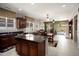 Open-concept kitchen with stainless appliances and large island seamlessly connects to the dining and living areas at 20523 N 267Th Ln, Buckeye, AZ 85396