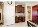 Kitchen area features a desk nook with dark wood cabinets and drawers, complemented by a white door at 20523 N 267Th Ln, Buckeye, AZ 85396