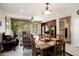 Bright dining room flows into the living room featuring an entertainment center and access to the backyard at 20523 N 267Th Ln, Buckeye, AZ 85396