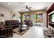 Bright living room featuring tile floors, sliding glass doors, and comfortable seating at 20523 N 267Th Ln, Buckeye, AZ 85396