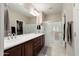 Bright main bathroom features a double sink vanity, walk-in shower and walk-in closet at 20523 N 267Th Ln, Buckeye, AZ 85396