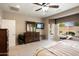 Bright main bedroom featuring a ceiling fan, window, and stylish wood furniture at 20523 N 267Th Ln, Buckeye, AZ 85396