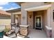 Inviting covered patio with stone accents and comfortable seating area at 20523 N 267Th Ln, Buckeye, AZ 85396