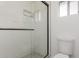 Bathroom shower with glass door, white tile, and modern fixtures at 2109 W El Alba Way, Chandler, AZ 85224
